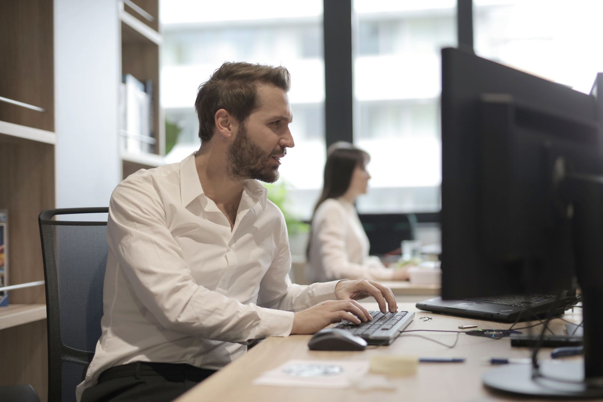Analysts working at desks in a bright office